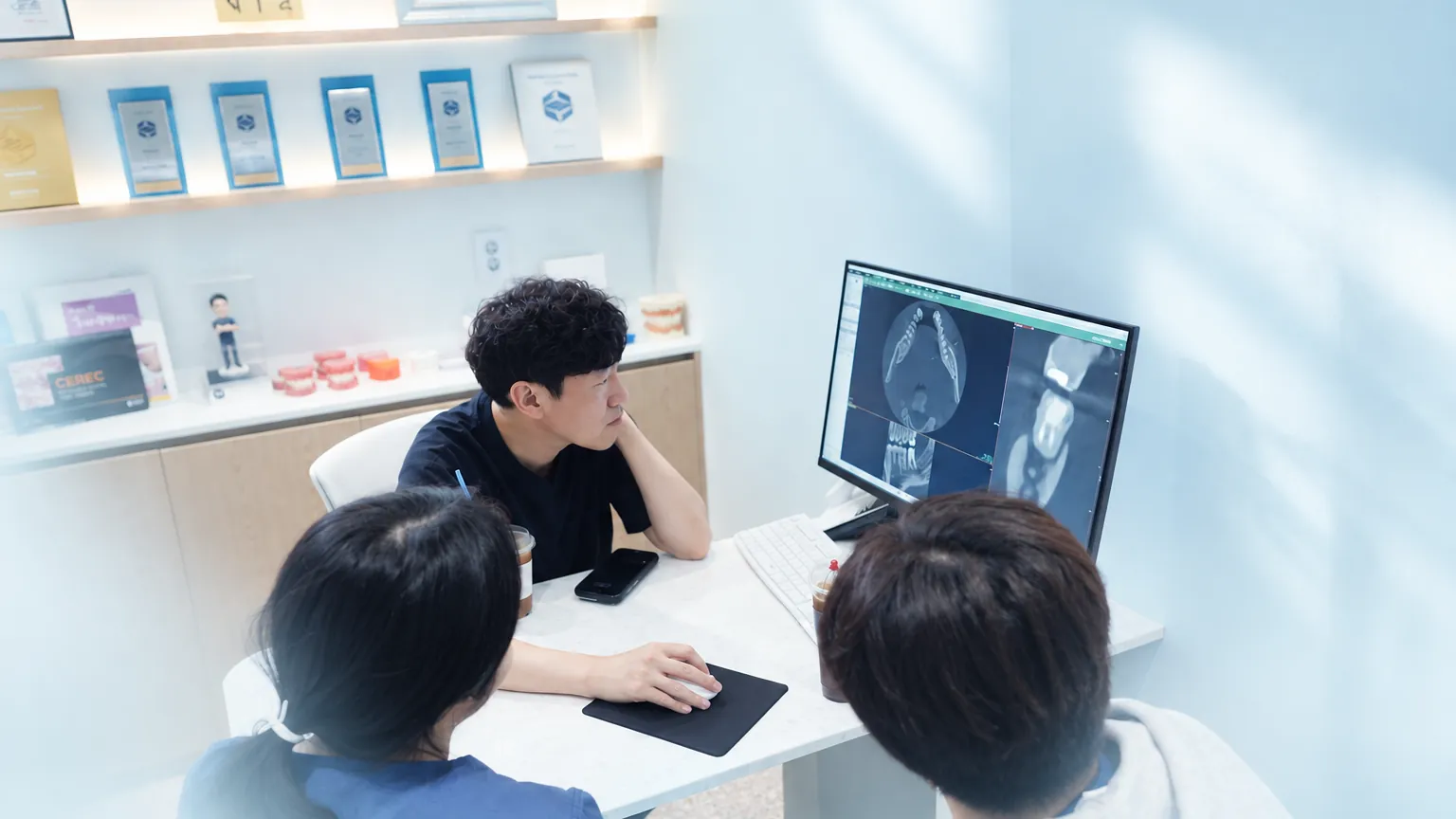 상담실 모니터의 CT 영상을 원장, 스태프와 함께 보는 환자